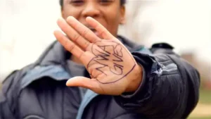 Women holding hand out with "NWA Gives" written on her palm outlined in a heart.