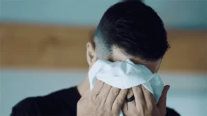 man wiping sweat with a cloth