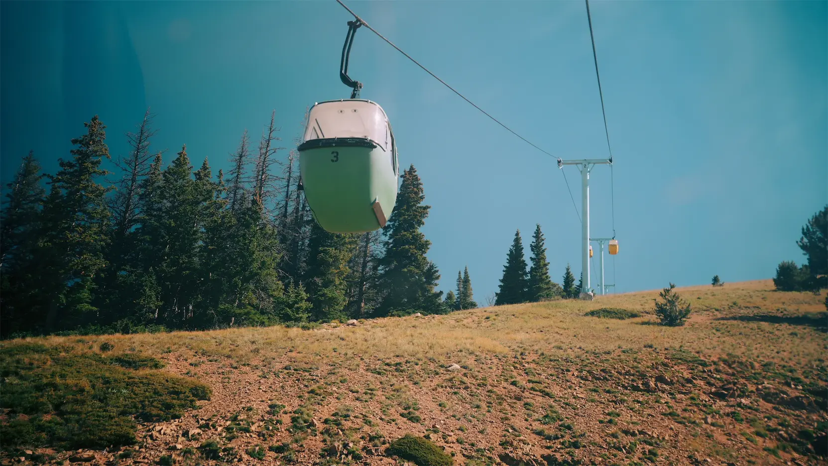 Gondola going up a mountain.
